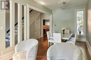 Ottawa townhouse for rent - A white chair is in the foreground of a well-lit room with a dining table and chairs.