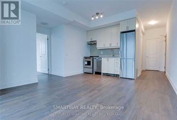 Milton (De Dempsey) condo for rent - A kitchen with white cabinets and a wooden floor.
