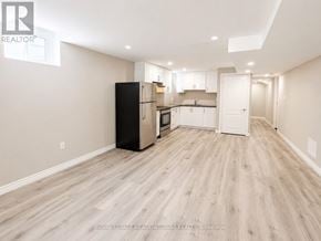 Milton (Be Beaty) apartment for rent - A spacious kitchen with a black refrigerator and wooden flooring.