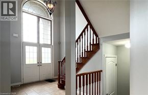 Ancaster apartment for rent - A chandelier hangs over a staircase in a home.