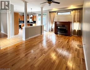 Ancaster apartment for rent - A spacious living room with wooden flooring and a fireplace.