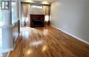 Ancaster apartment for rent - A living room with a fireplace and wood flooring.