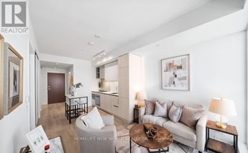 Vaughan (Concord) condo for rent - A living room with a couch, coffee table, and a painting on the wall.