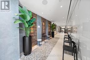 Vaughan (Concord) condo for rent - A modern office lobby with a reception desk and chairs.