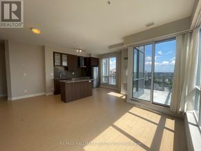Richmond Hill (South Richvale) condo for rent - A spacious living room with a kitchen area and sliding glass doors leading to a balcony.