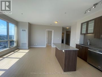 Richmond Hill (South Richvale) condo for rent - A spacious kitchen with wooden cabinets and a central island.