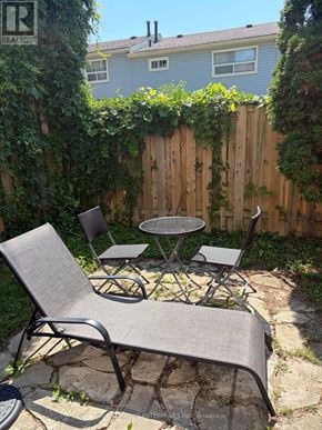 Mississauga (Port Credit) townhouse for rent - A backyard with a table and chairs.