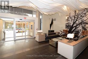 Toronto (High Park North) condo for rent - A real estate office with a white reception desk and a tree sculpture.