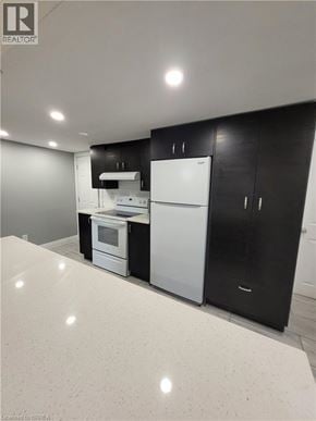 Cambridge apartment for rent - A kitchen with black cabinets and white appliances.