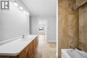 Cambridge apartment for rent - A bathroom with a white sink and brown tiled walls.
