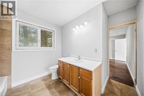 Cambridge apartment for rent - A bathroom with a toilet, sink, and window.