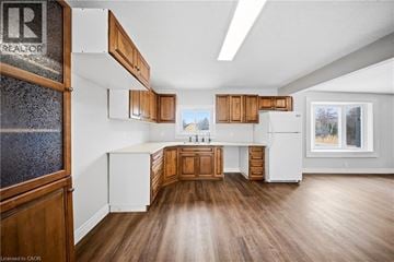 Cambridge apartment for rent - A kitchen with wooden cabinets and a white refrigerator.