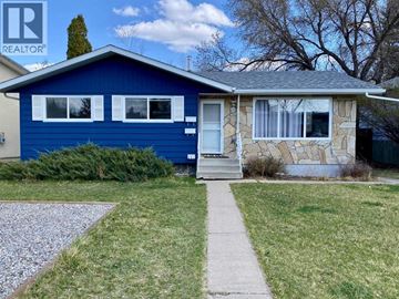 Lethbridge apartment for rent - A blue house with a white door and windows is for sale.