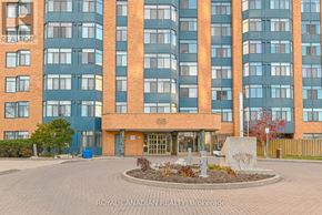 Toronto (Milliken) condo for rent - A large building with a circular planter in front of it.
