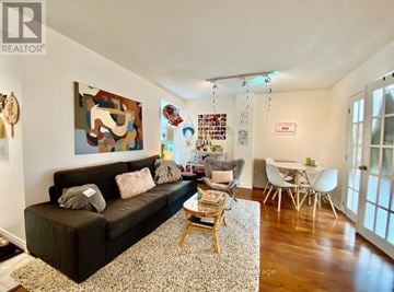 Toronto (Church-Yonge Corridor) condo for rent - A living room with a brown couch and a painting on the wall.