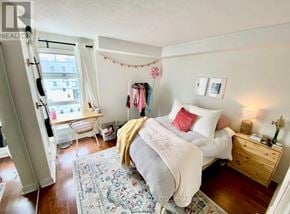 Toronto (Church-Yonge Corridor) condo for rent - A bedroom with a bed, nightstand, and chair.