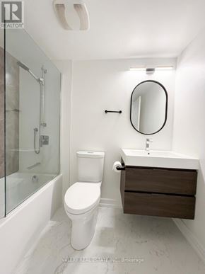 Toronto (Bendale) condo for rent - A white toilet sits next to a sink in a bathroom.