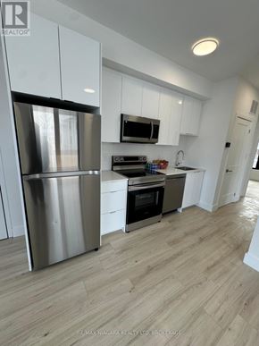 Niagara Falls (Oldfield) townhouse for rent - A modern kitchen with white cabinets and stainless steel appliances.