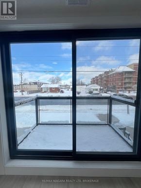 Niagara Falls (Oldfield) townhouse for rent - A view from inside a room looking out to a snowy landscape through a large window.