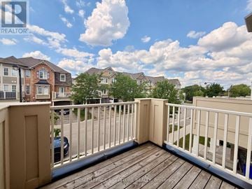 Milton (Wi Willmott) townhouse for rent - A balcony with a railing and a view of a residential area.