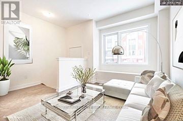 Toronto (Downsview-Roding-Cfb) townhouse for rent - A living room with a glass coffee table and a couch.