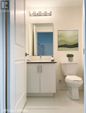 Toronto (Downsview-Roding-Cfb) townhouse for rent - A white toilet sits next to a sink in a bathroom.