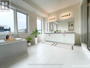 Toronto (Downsview-Roding-Cfb) townhouse for rent - A bathroom with a large mirror, a sink, and a window.