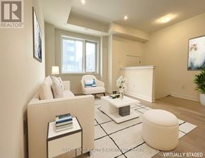Toronto (Downsview-Roding-Cfb) townhouse for rent - A living room with a white couch, a white ottoman, and a white coffee table.