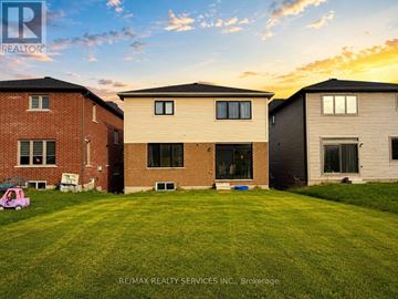 Cobourg apartment for rent - Three houses are shown in the image with a grassy lawn in front.
