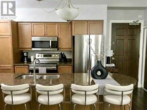 Toronto (Bayview Village) condo for rent - A kitchen with brown cabinets and a granite countertop.