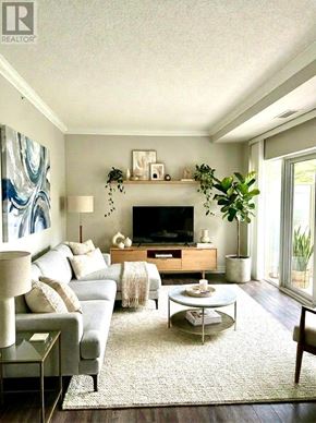 Toronto (Bayview Village) condo for rent - A living room with a grey couch, a white coffee table, and a fireplace.