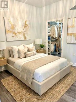 Toronto (Bayview Village) condo for rent - A bedroom with a large bed and a painting on the wall.