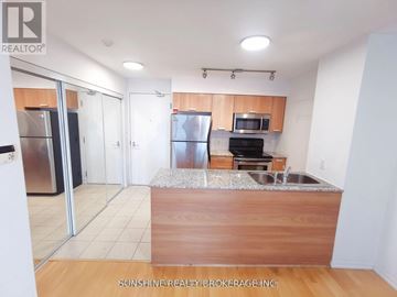 Toronto (Bay Street Corridor) condo for rent - A kitchen with a wooden counter top and stainless steel appliances.