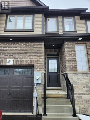 Midland townhouse for rent - A house with a black door and a garage door.