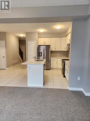 Midland townhouse for rent - A kitchen with white cabinets and a white island.