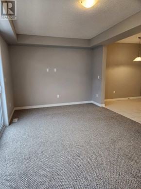 Midland townhouse for rent - A carpeted room with a light on the ceiling.
