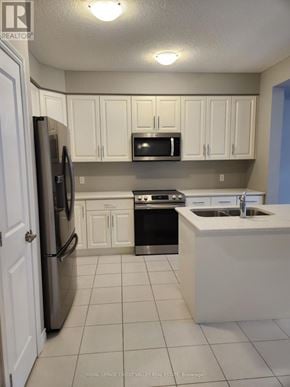 Midland townhouse for rent - A kitchen with white cabinets and appliances.