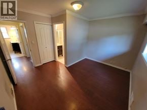 Burnaby apartment for rent - A room with a wooden floor and white walls.
