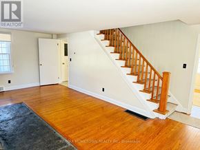 Augusta apartment for rent - A room with a wooden floor and a staircase leading to the upper floor.