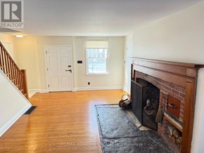 Augusta apartment for rent - A room with a fireplace and a door in the background.