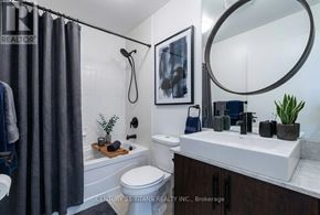 Toronto (Waterfront Communities) condo for rent - A bathroom with a toilet, sink, and a mirror.