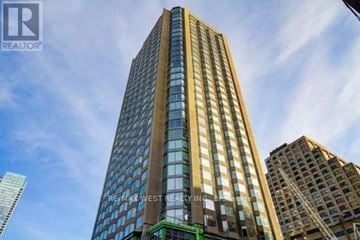 Toronto (Annex) condo for rent - A tall building with a glass facade is the main focus of the image.