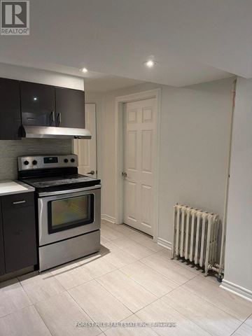 Toronto (University) apartment for rent - A kitchen with a stove top oven and a microwave.