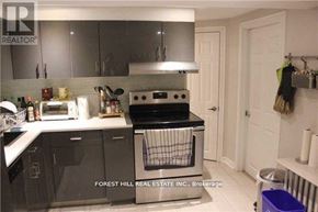 Toronto (University) apartment for rent - A kitchen with Forest Hill Real Estate Inc. written on the wall.