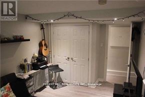 Toronto (University) apartment for rent - A room with a guitar hanging on the wall and a white door.