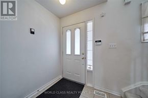 Ajax (Northeast Ajax) apartment for rent - A white door is in a room with a light switch on the wall.
