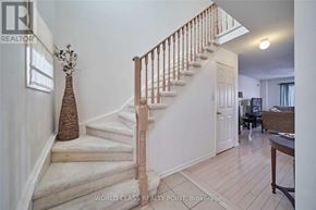 Ajax (Northeast Ajax) apartment for rent - A staircase with a wooden banister and a vase on the landing.