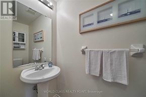 Ajax (Northeast Ajax) apartment for rent - A bathroom with a sink, mirror, towel rack and a picture frame.