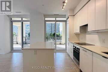 Mississauga (Fairview) condo for rent - A kitchen with white cabinets and a countertop with a sign that says KIGO REALTY INC., Brokerage.