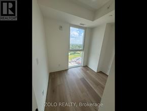 Brantford condo for rent - A room with a view of the outdoors through a sliding glass door.